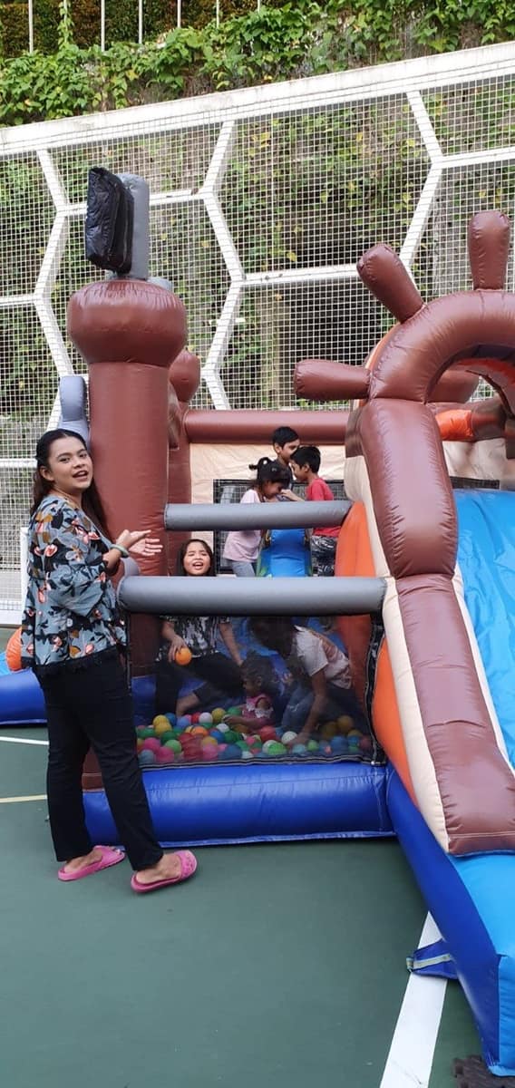 Mum and kids at a pirate-ship ball pit