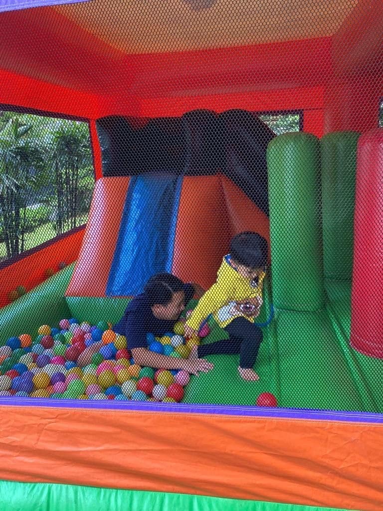 Kid mid-slide into a ball pit