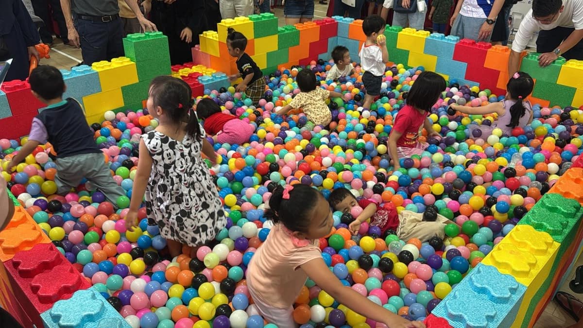Children playing in a colourful LEGO-block ball pit by BounceParkSG