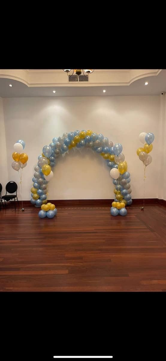 Gold and silver balloon arch at a doorway