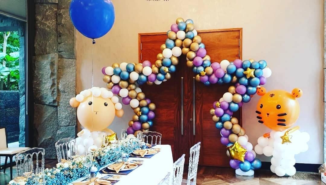 Pastel balloon arch with animal cutouts