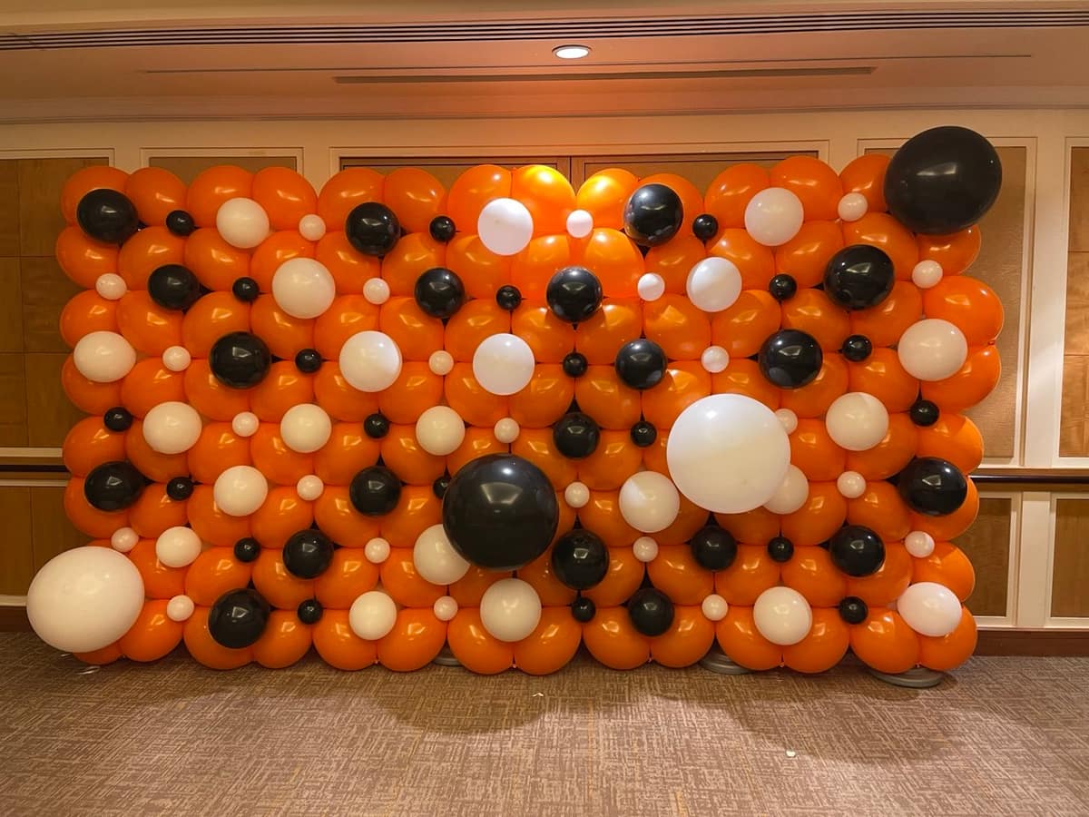 Orange, black and white polka dot balloon wall
