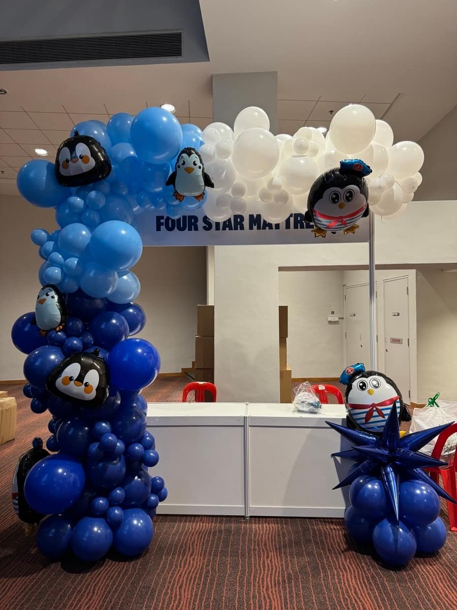Blue and white penguin themed balloon column