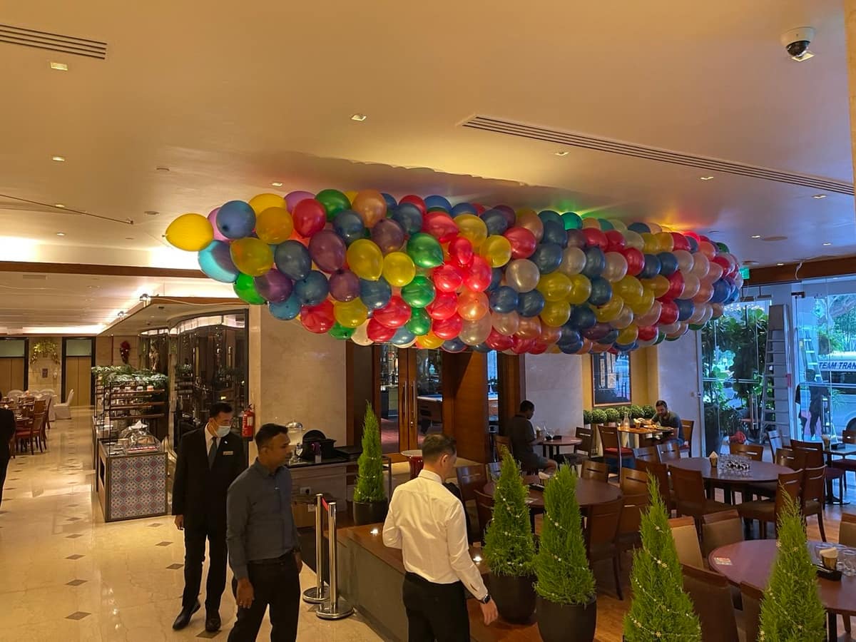 Rainbow balloon cluster in a lobby