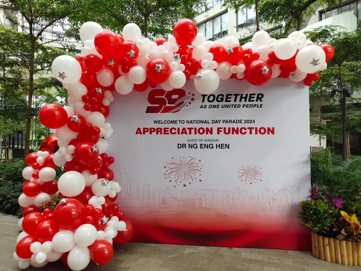 Red and white balloon arch for an NDP appreciation event