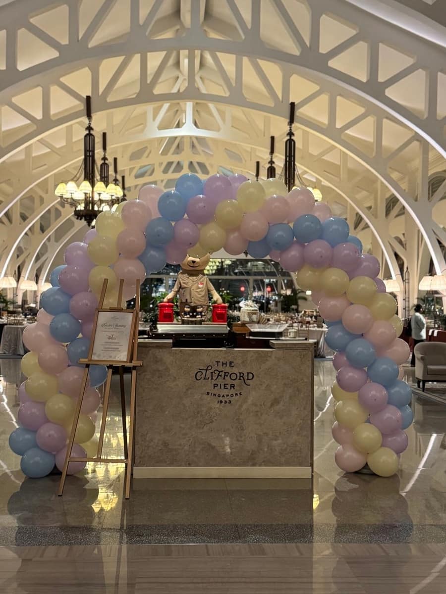 Pastel balloon arch at a venue entrance