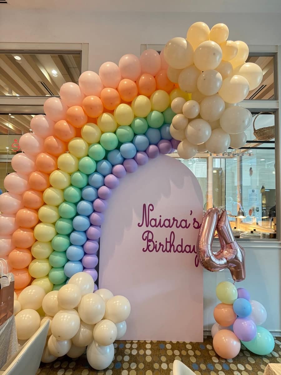 Rainbow balloon arch at a kids birthday party by BounceParkSG