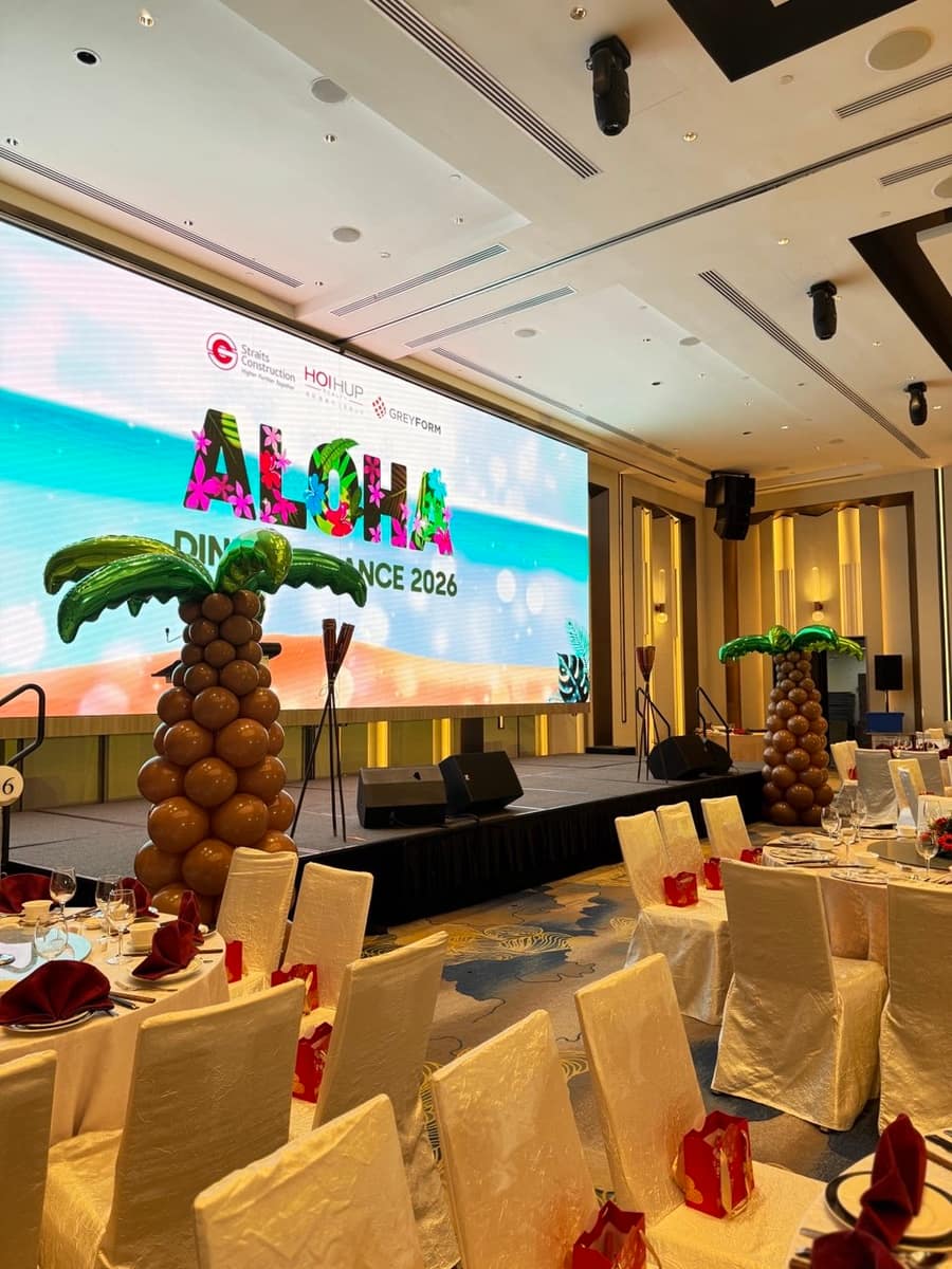 Aloha themed balloon stage with palm tree decor