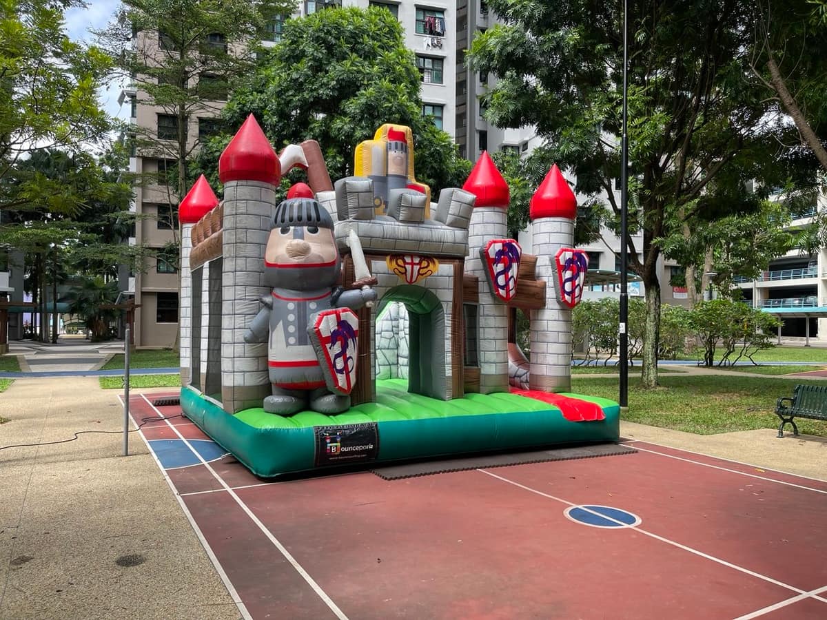 Knight bouncy castle set up in an HDB courtyard
