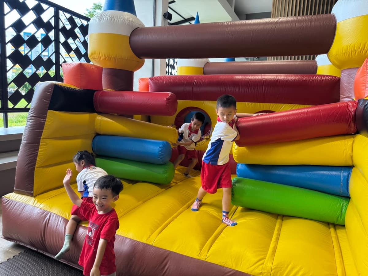 Kids playing on an obstacle course bouncy castle