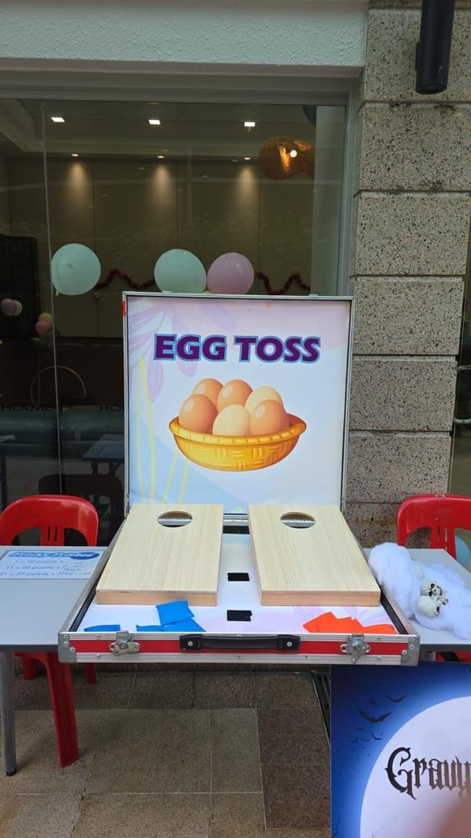 Egg toss and cornhole carnival games