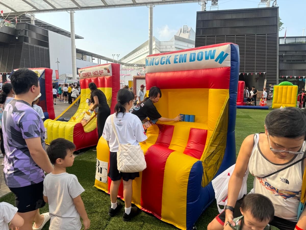 Kids playing Knockem Down bottle toss game