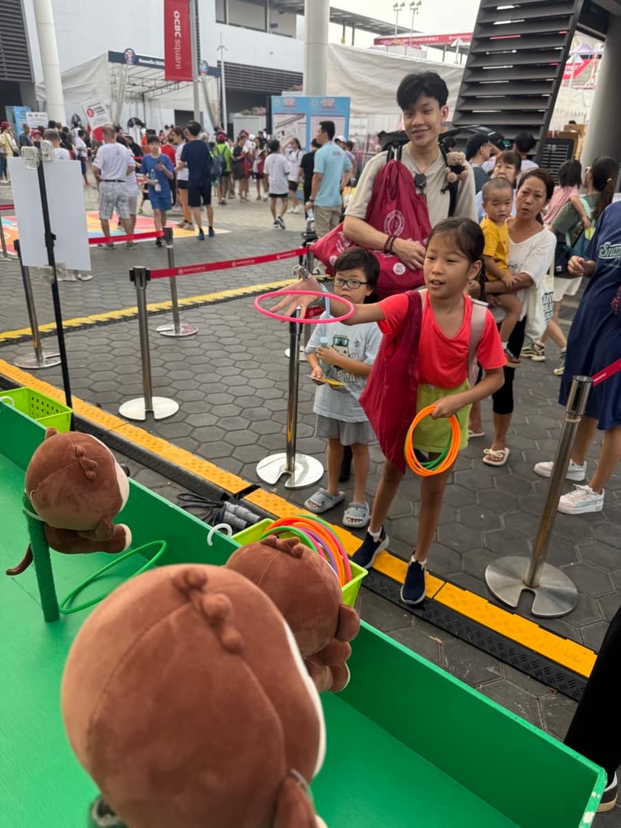Girls playing ring toss at a carnival booth