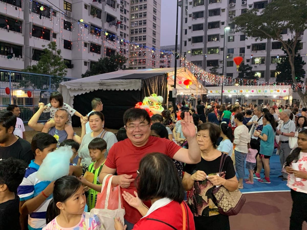 Crowd at a night carnival in an HDB estate