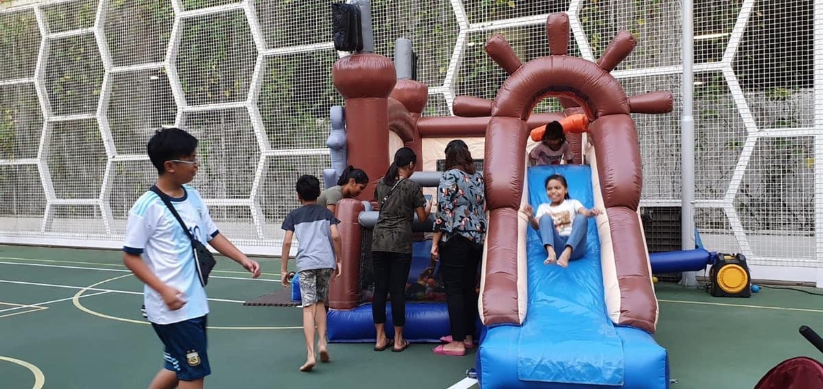 Crowd around a pirate ship bouncy castle