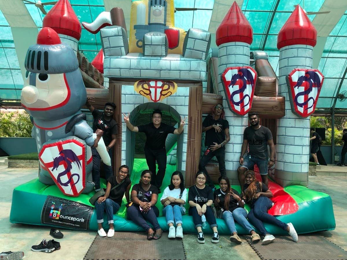 Group in front of a knight bouncy castle