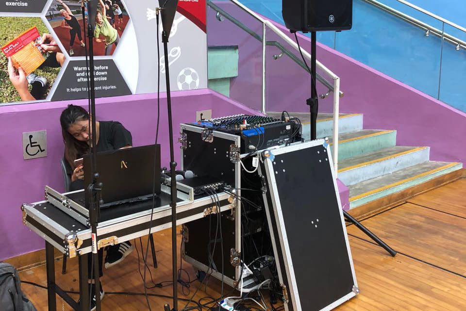 Sound system and PA setup with mixer and speaker stands at an event